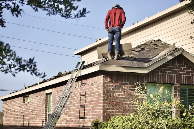 Professional roofer working on a residential roof in East End